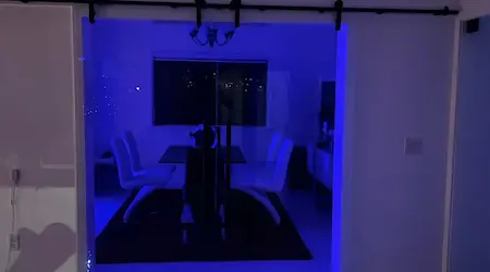 Custom sliding glass barn door with matte black hardware and curved frameless shower enclosure with gold hardware — Glass Designer LLC Fort Myers FL