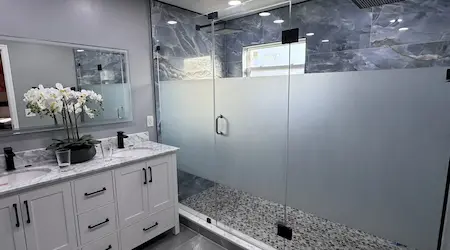 Frosted frameless shower enclosure with matte black hardware installed by Glass Designer LLC
