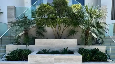 Frameless glass stair railing installed at commercial exterior with tropical landscaping — Glass Designer LLC Fort Myers FL